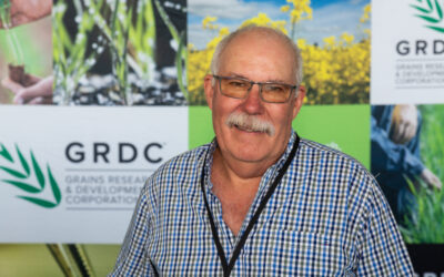 A photo of SAGIT chair Andrew Barr in standing in front of a colourful GRDC banner